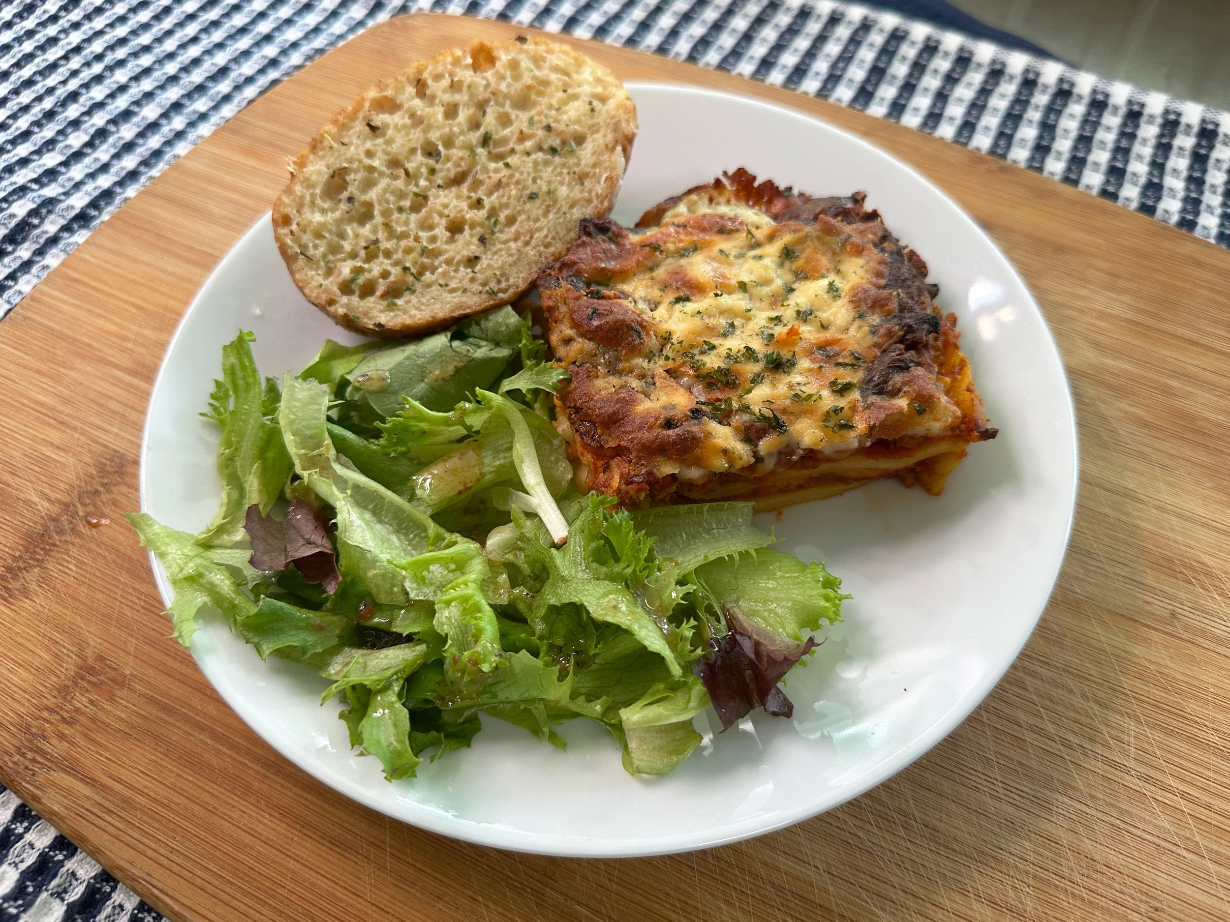 Boki's Kitchen lasagna with a side salad and bread