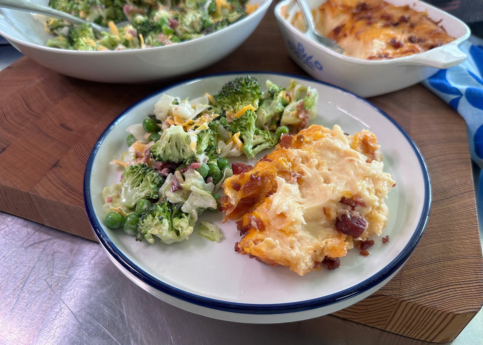 Twice baked mashed potatoes plated with a side of layered salad.
