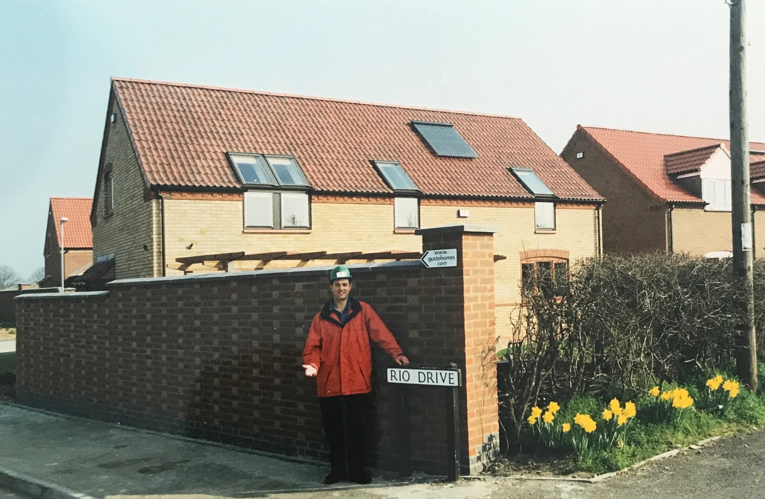 Steff Wright stood on an early Gusto Homes development at Millennium Green in the 1990s with Rio Drive street sign and newly built houses.