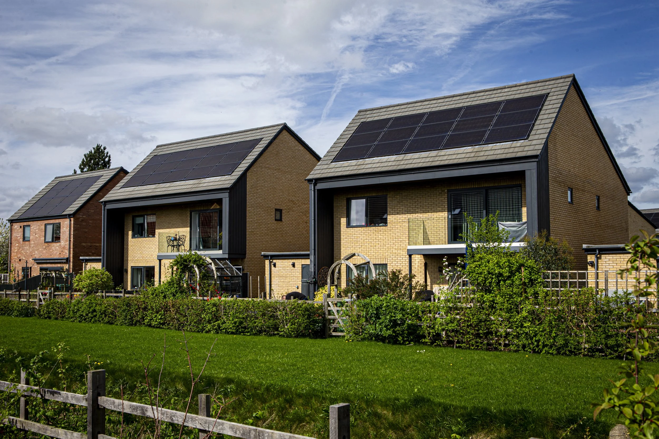 Modern energy-efficient Gusto Homes with rooftop solar panels overlooking green space at Collingham Brook.