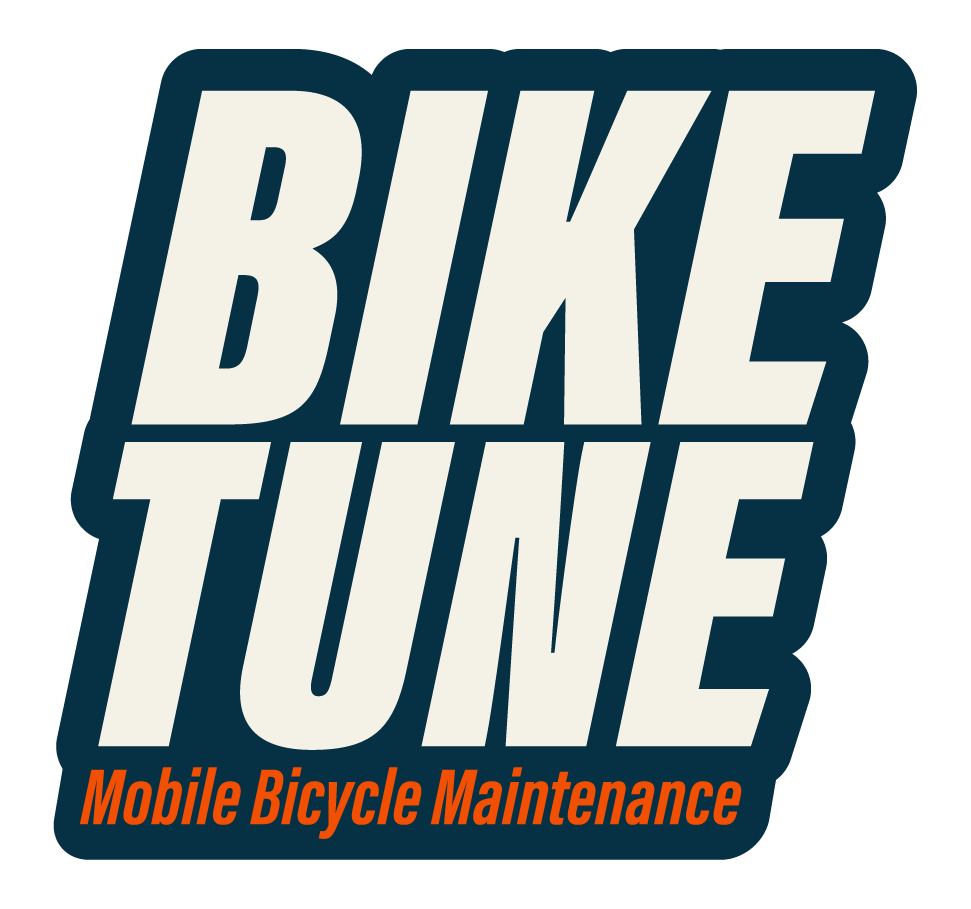 Logo for Bike Tune, a mobile bicycle maintenance service, with the text 'Bike Tune' in large cream-colored letters outlined in dark blue, and 'Mobile Bicycle Maintenance' in smaller orange text beneath.