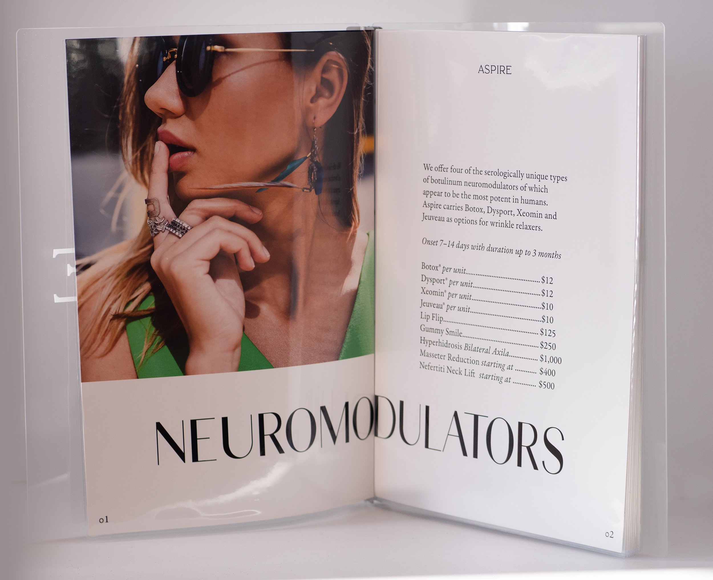 Open brochure displaying a woman wearing sunglasses and jewelry on the left page, and text about neuromodulators and treatments on the right page.