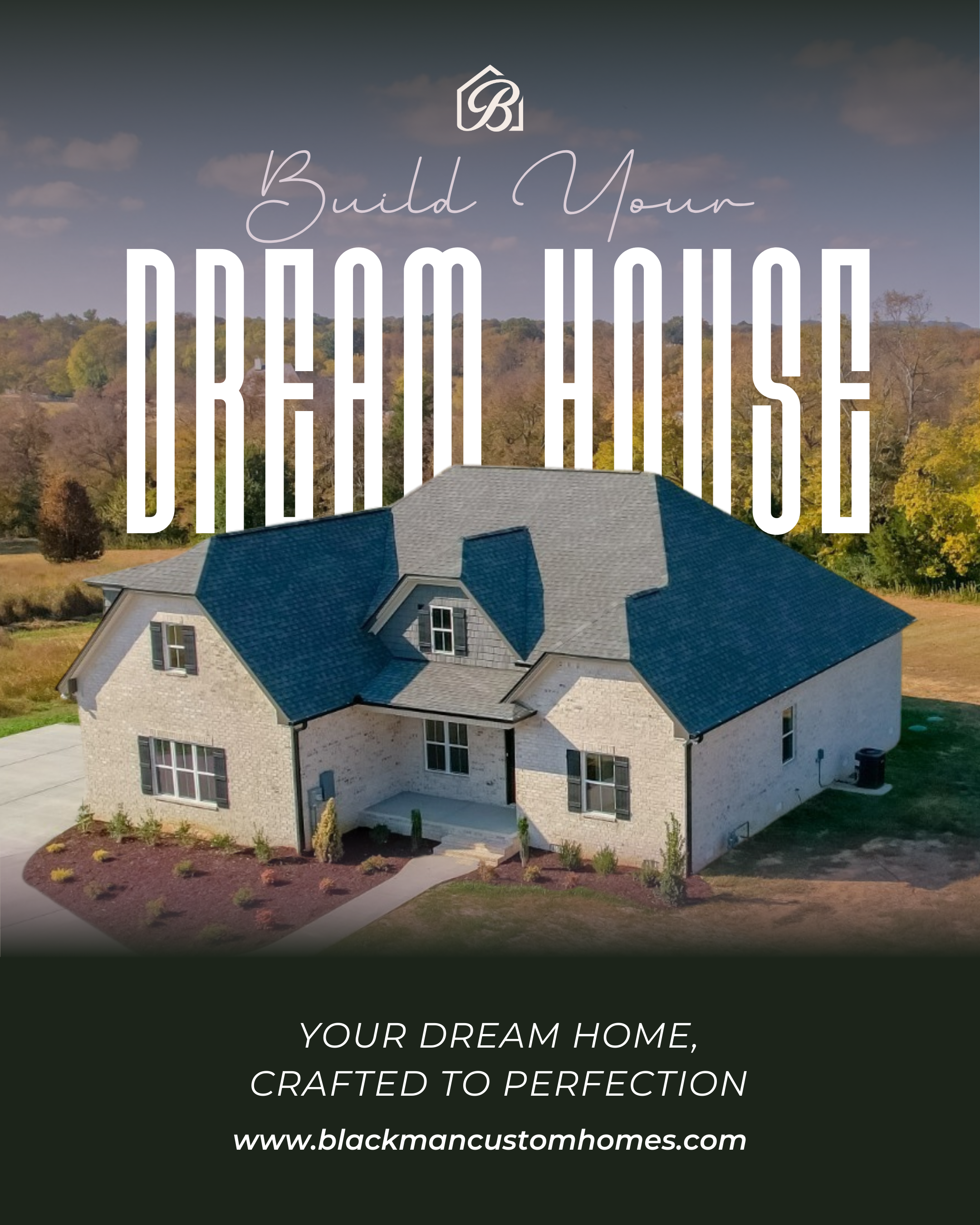 A large house with a blue roof, beige brick walls, and a small front porch, surrounded by a manicured lawn and shrubbery, with a wooded area and hills in the background.