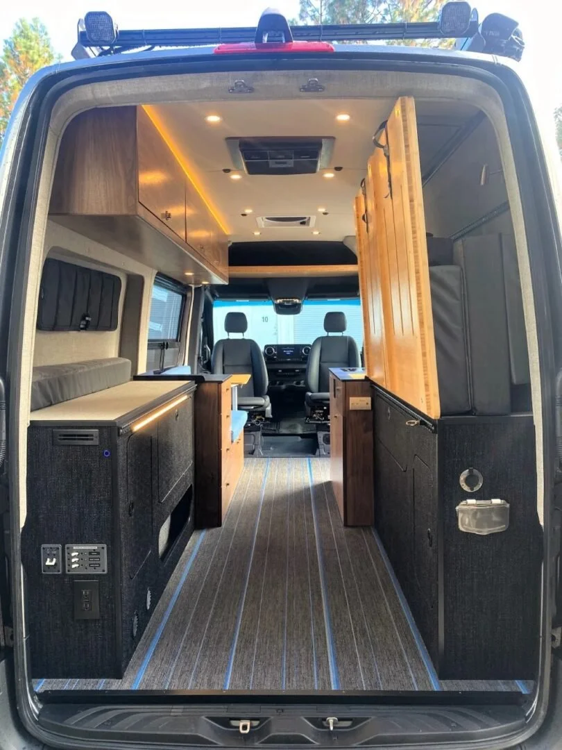 LED lighting and overhead storage in Wolf Mountain Sprinter Van conversion, storage space, custom woodwork