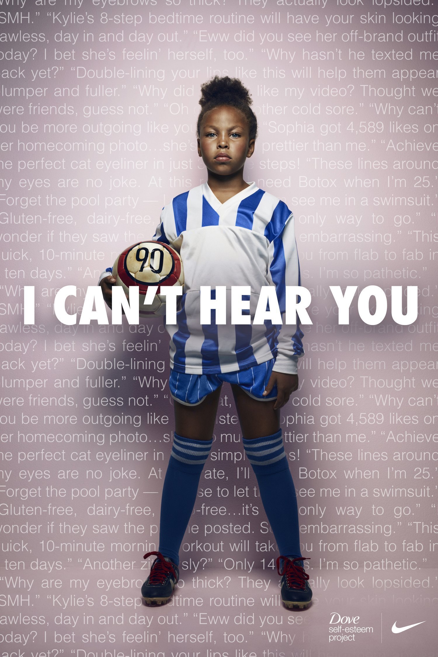 Young girl dressed in a blue and white striped soccer uniform holding a soccer ball with the number 90, standing with a serious expression on her face against a pink background with white text. The overlay text says, 'I CAN'T HEAR YOU.' Dove and Nike