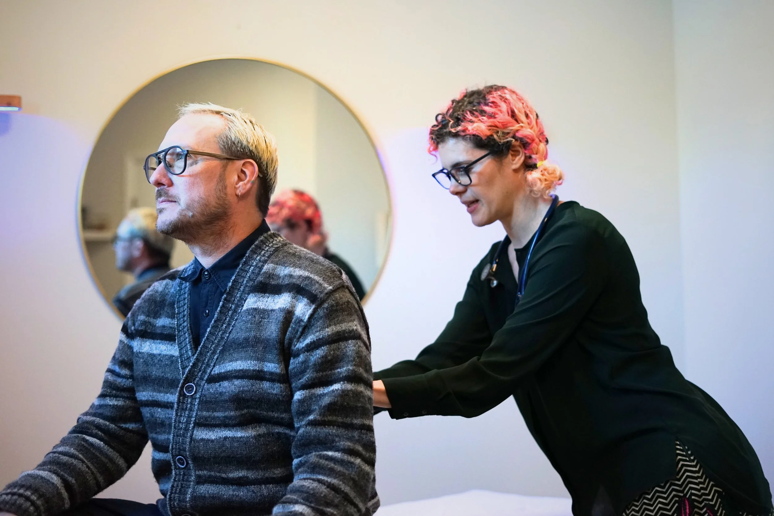 Dr Rodrigues assesses a patient's back in her office