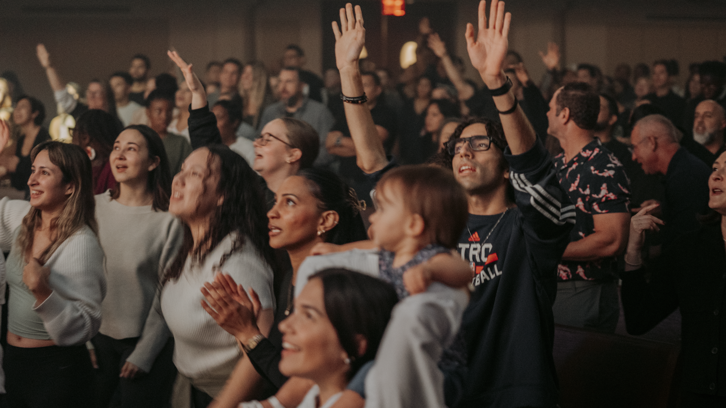 Group of people and leaders worshiping during a Church United event