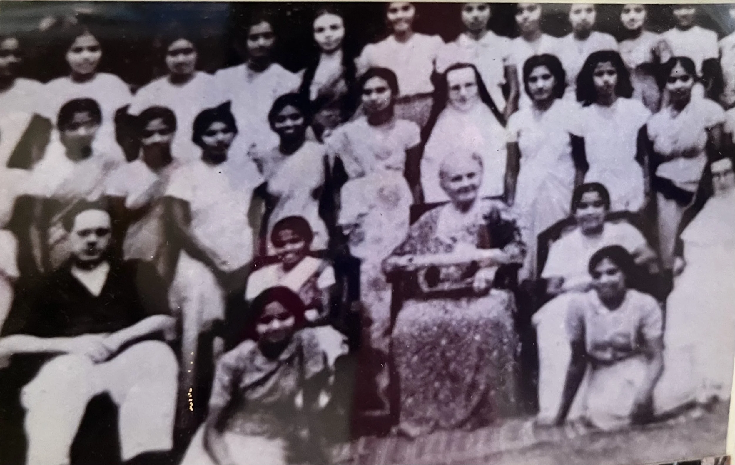 Maria Montessori with students in historical photograph