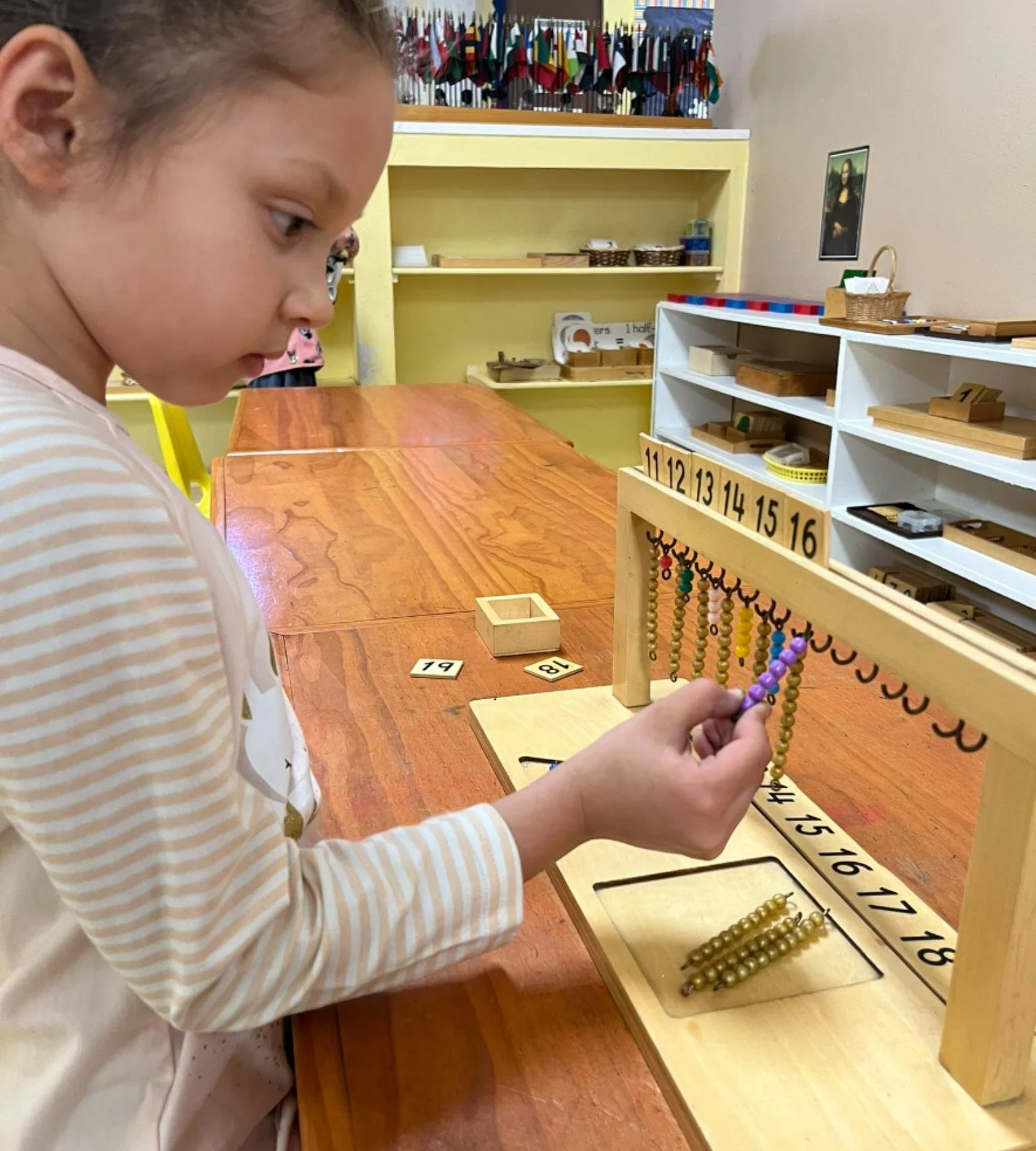 Preschooler working on Montessori math materials in Austin, Texas