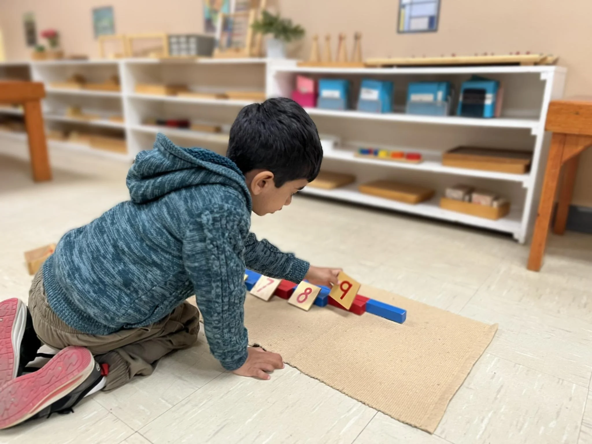 Student engaged in hands-on math activities at an Austin Montessori preschool