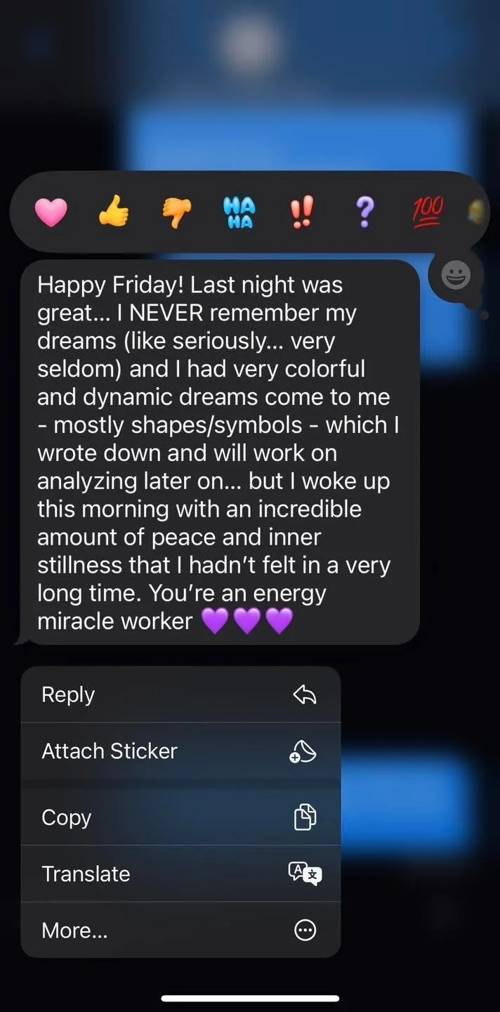 A screenshot of a messaging app conversation with a text message expressing gratitude and happiness about a dream and inner peace, accompanied by purple heart emojis. Above the message are emoji reactions including a pink heart, thumbs up, thumbs dow