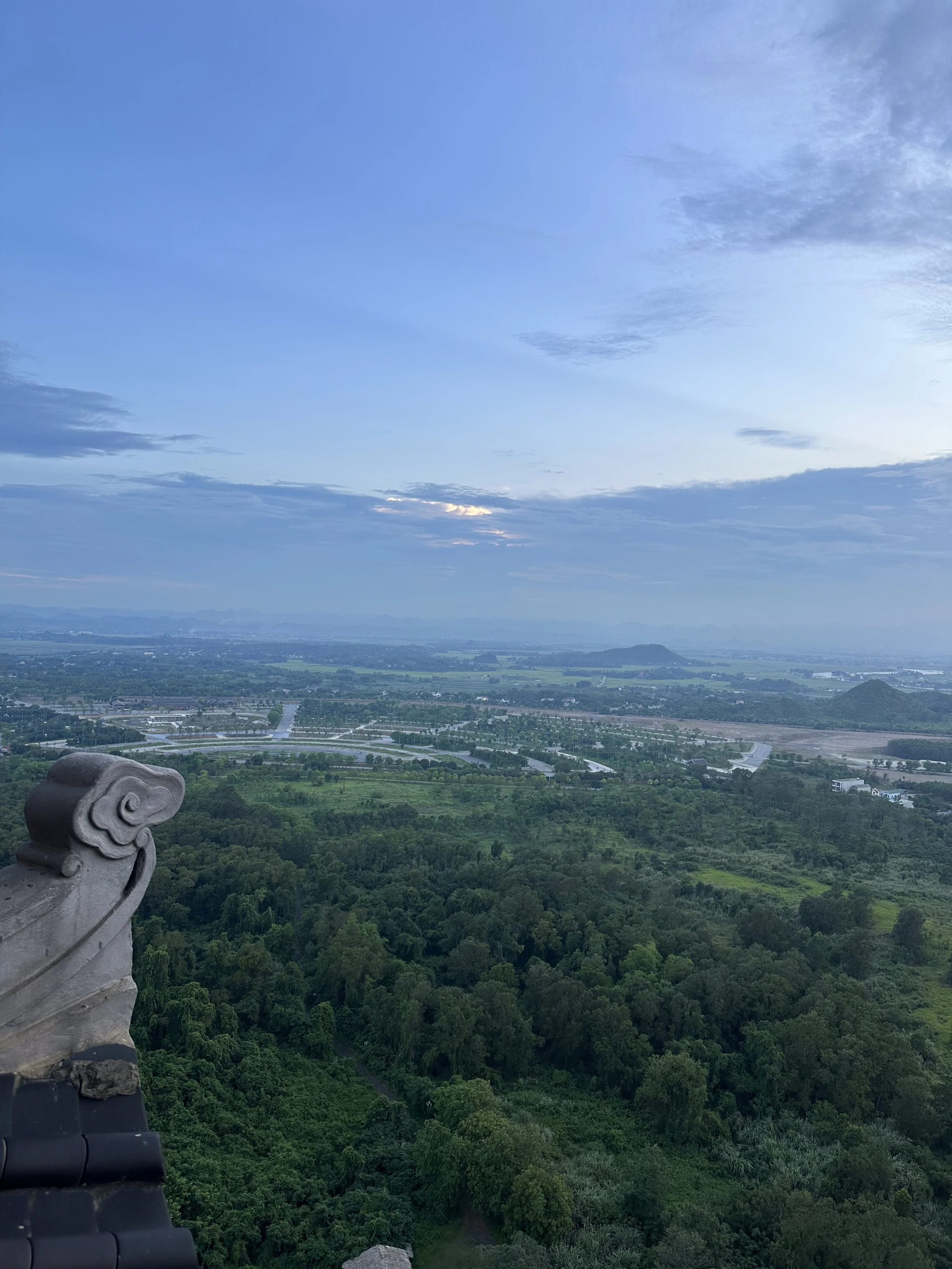 In the distance, the empty parking lot of the temple complex.