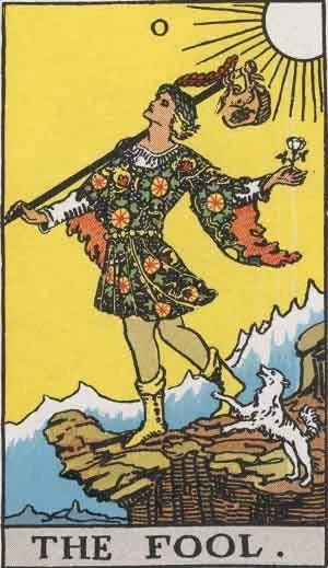 The Fool tarot card showing a traveller near a cliff with a white dog, carrying a small bundle and holding a white rose.