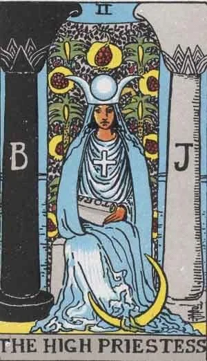 The High Priestess tarot card showing a seated woman between black and white pillars, holding a scroll with a crescent moon at her feet.