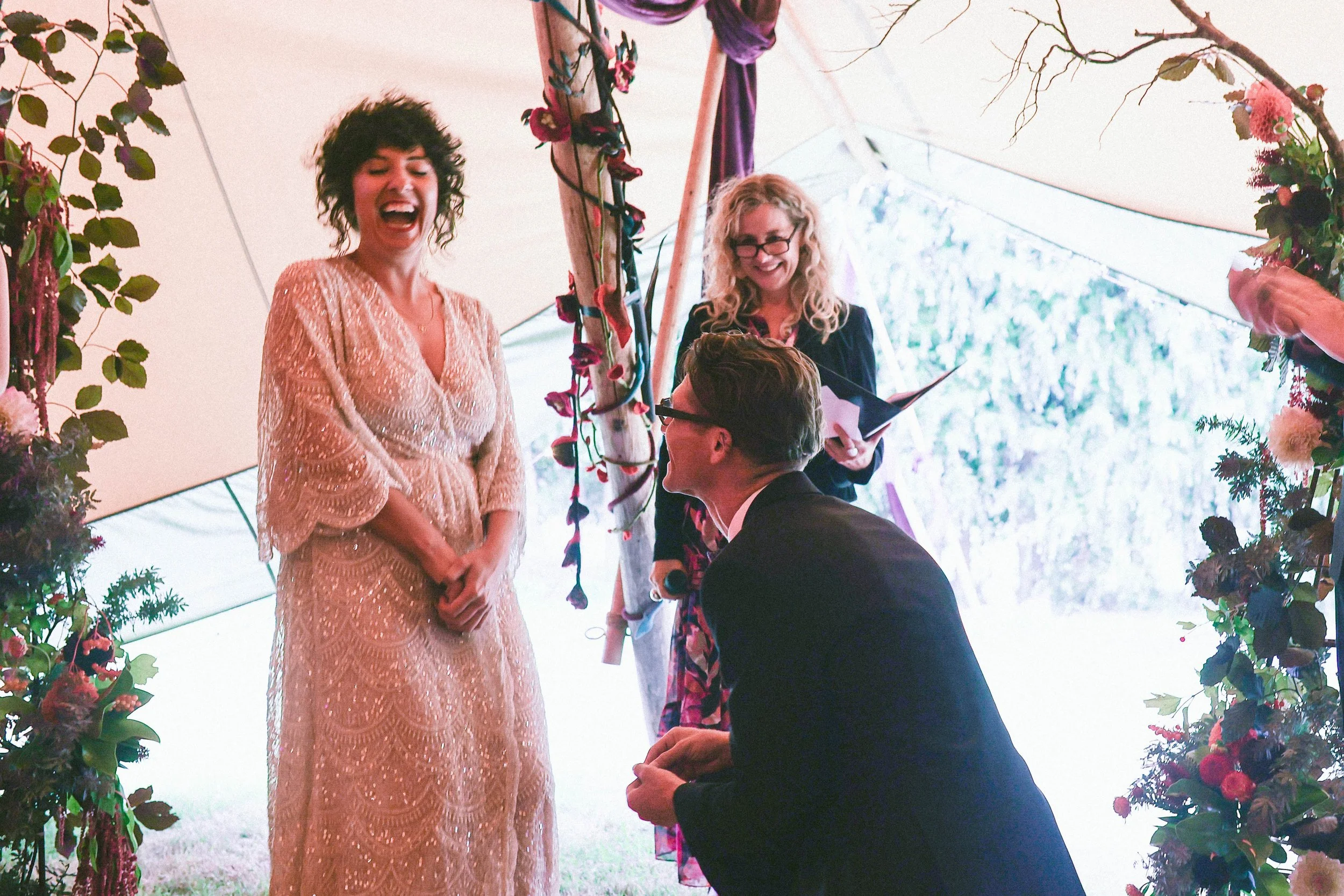Laurie’s customers, Mariana and Carmen holding hands on a green lawn on their wedding day.