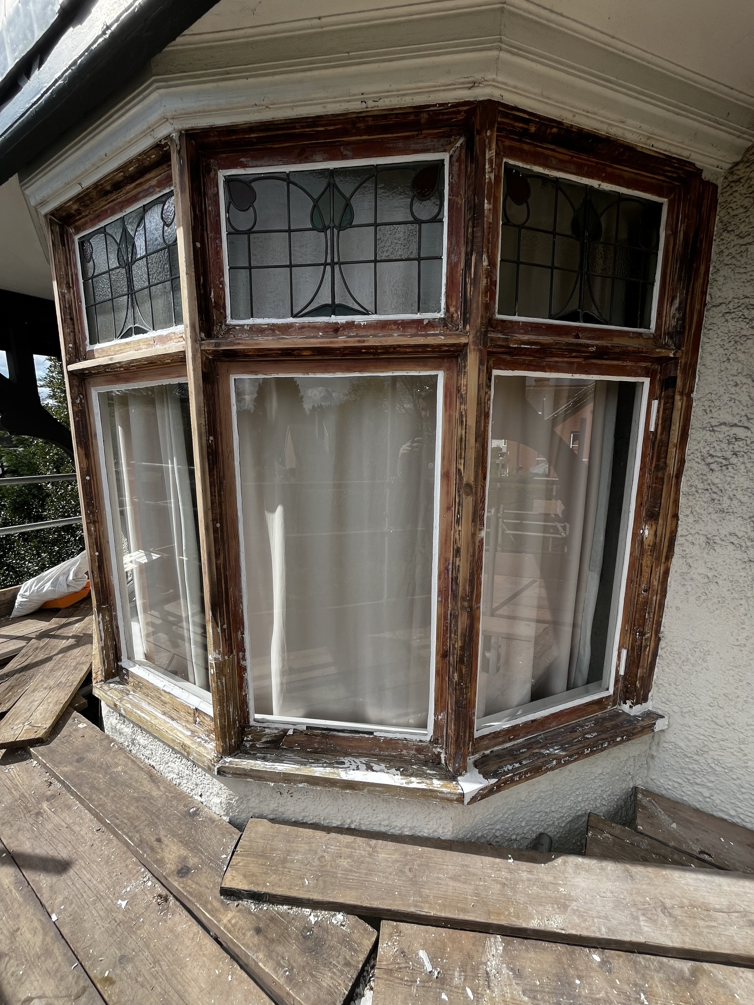 Bay window existing paint stripped off using IR heat gun ready for prep