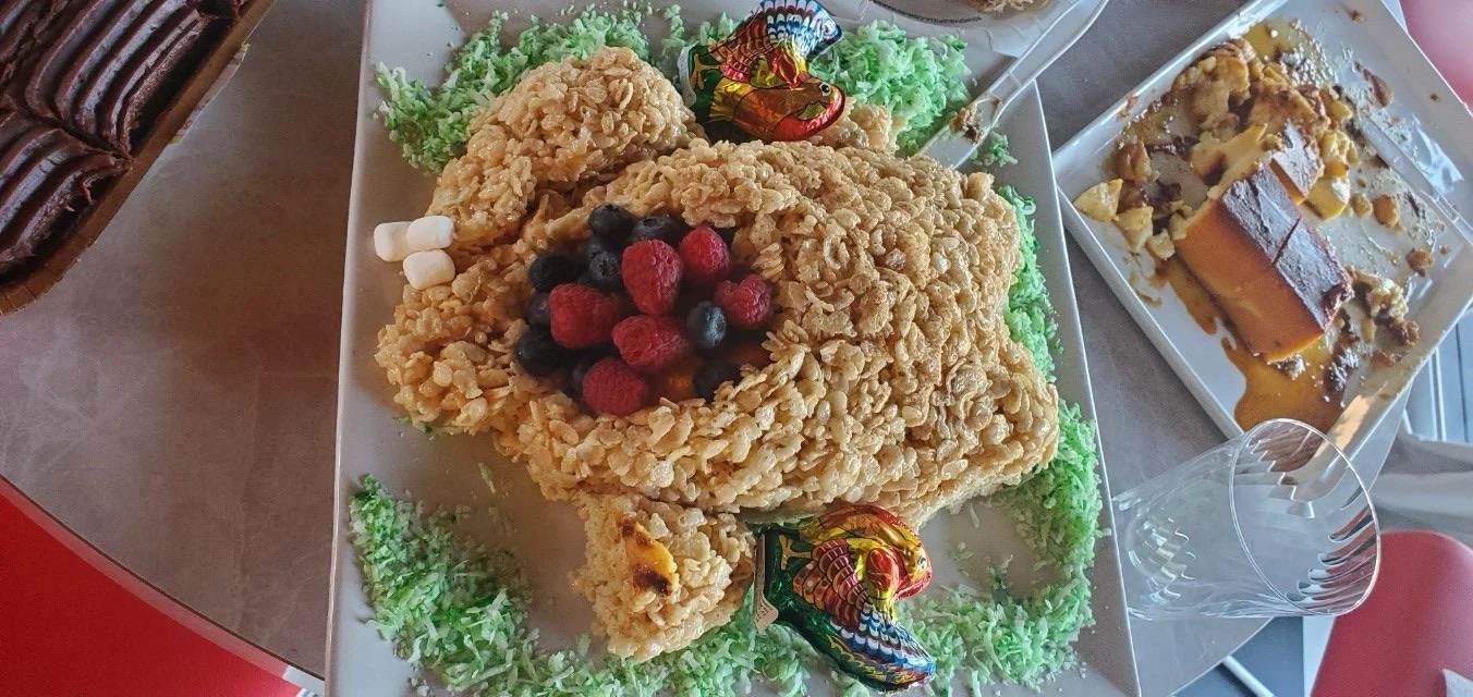 Fried chicken with berries and edamame on a white platter, decorated with green shredded lettuce, at a celebration or party.