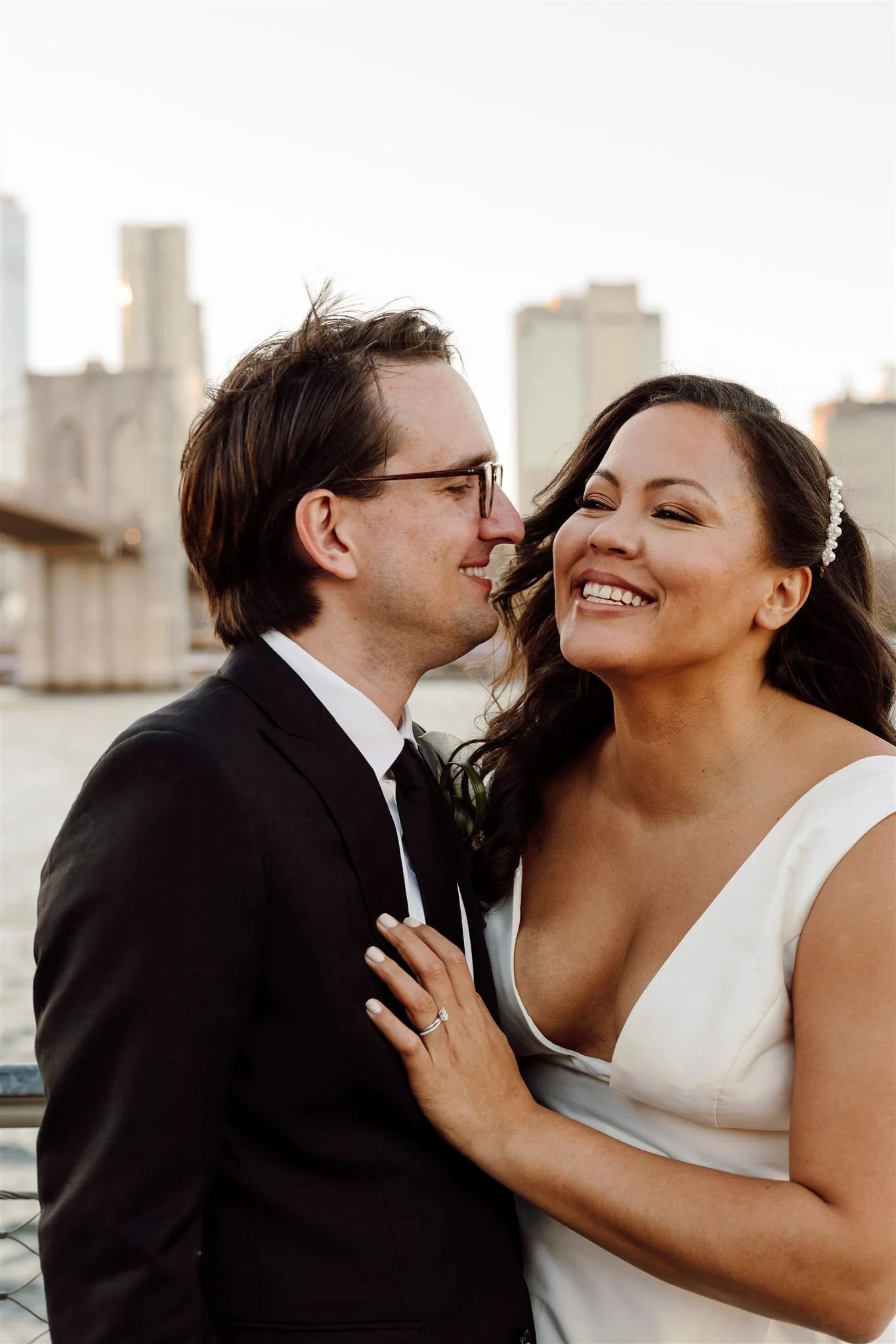 A newlywed leaning in to kiss their partner's cheek
