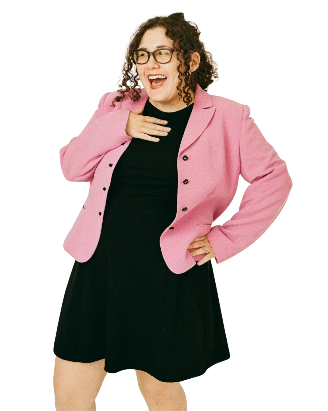 Marissa smiling with one hand on her hip and the other on her chest