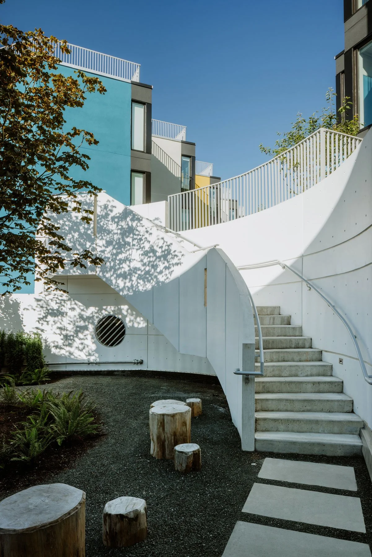 Considered Design Vancouver spiral staircase, log seating, mature tree planting. Landscape Archtiects, Vancouver