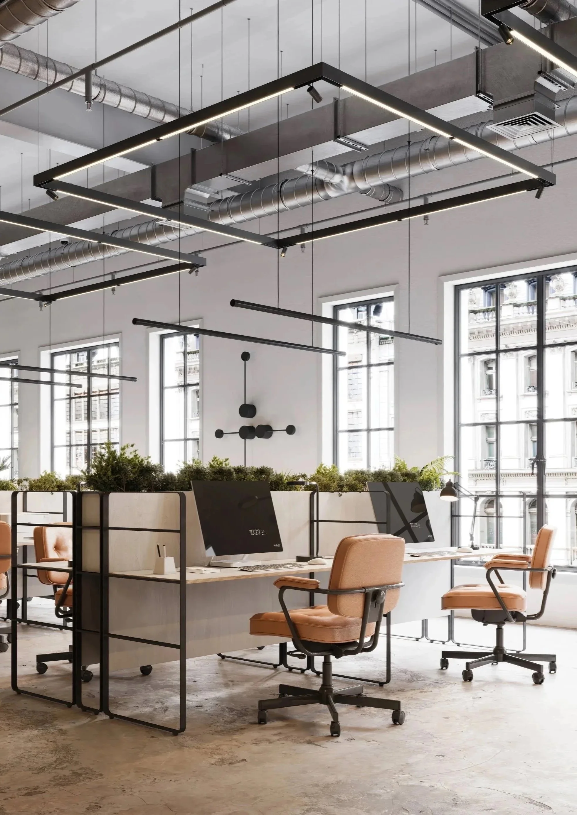 Modern open-plan office with multiple workstations, computer monitors, ergonomic chairs, large windows, and industrial-style ceiling with exposed ductwork and geometric lighting fixtures.
