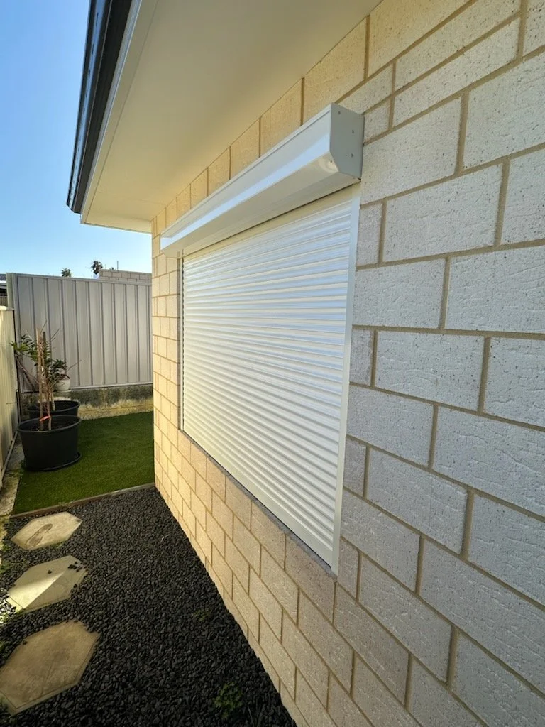 White coloured 'In Reveal' Security Window Roller Shutter installed to protect against the sun, noise and offering additional protection for those inside. All installed by Coastal Shade and Shutters, right here in Bunbury