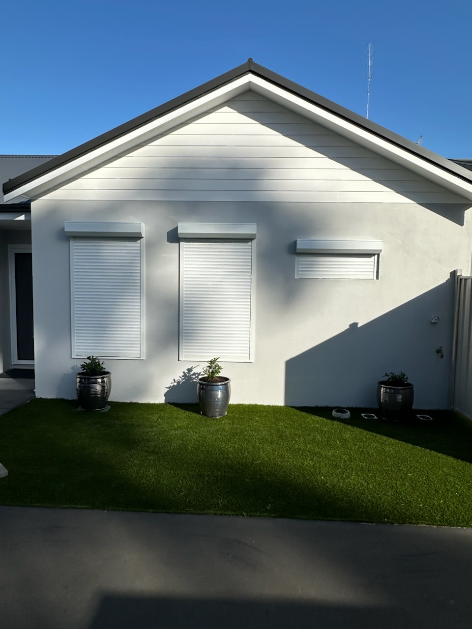 On Wall Security Roller Shutters installed here in Bunbury. White in colour. These help protect the client from incoming car lights as well as offering extreme protection against the morning sun and noise traffic. All while providing a sleek and mode
