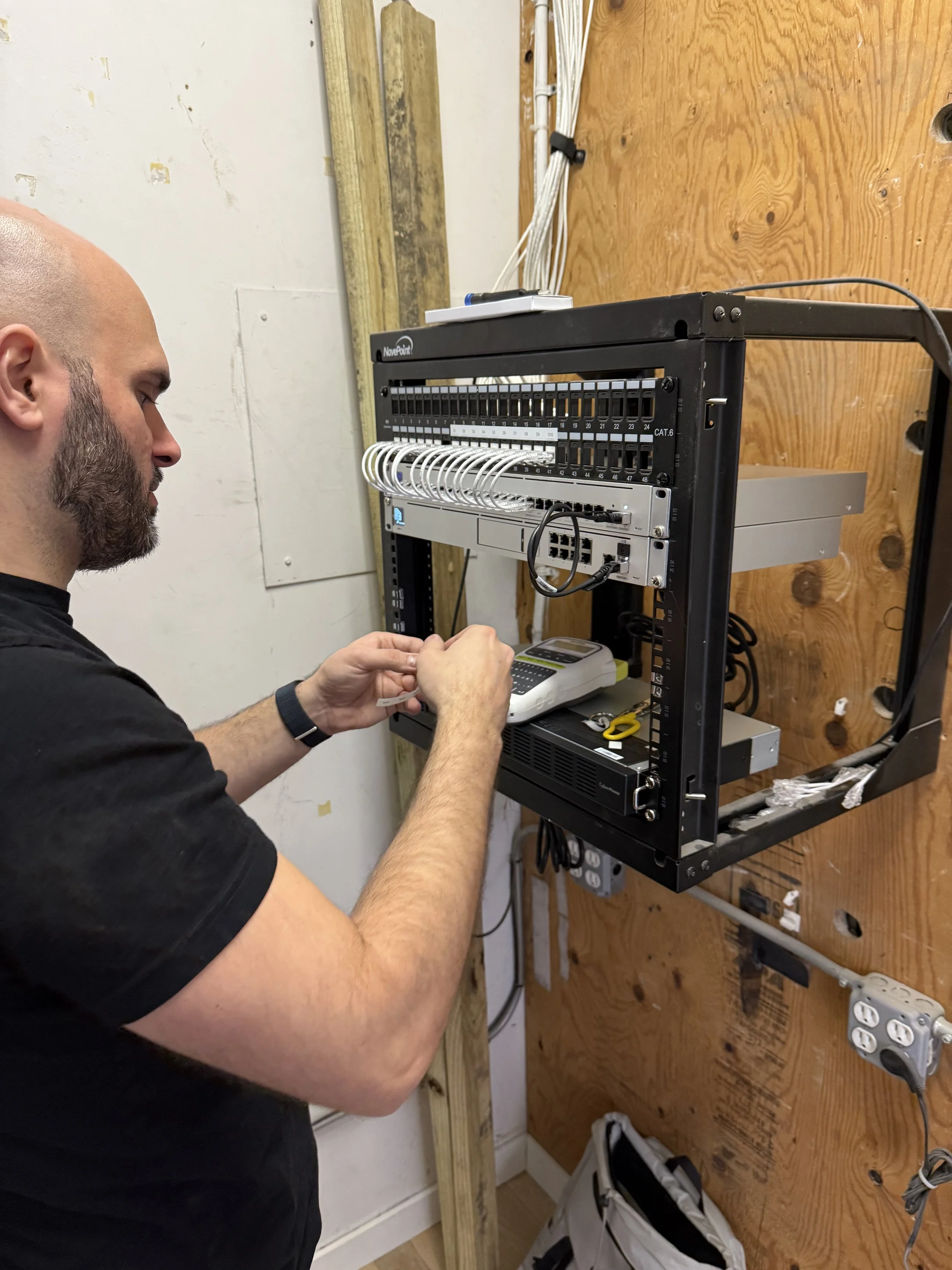 Installing network rack accessories and labeling.