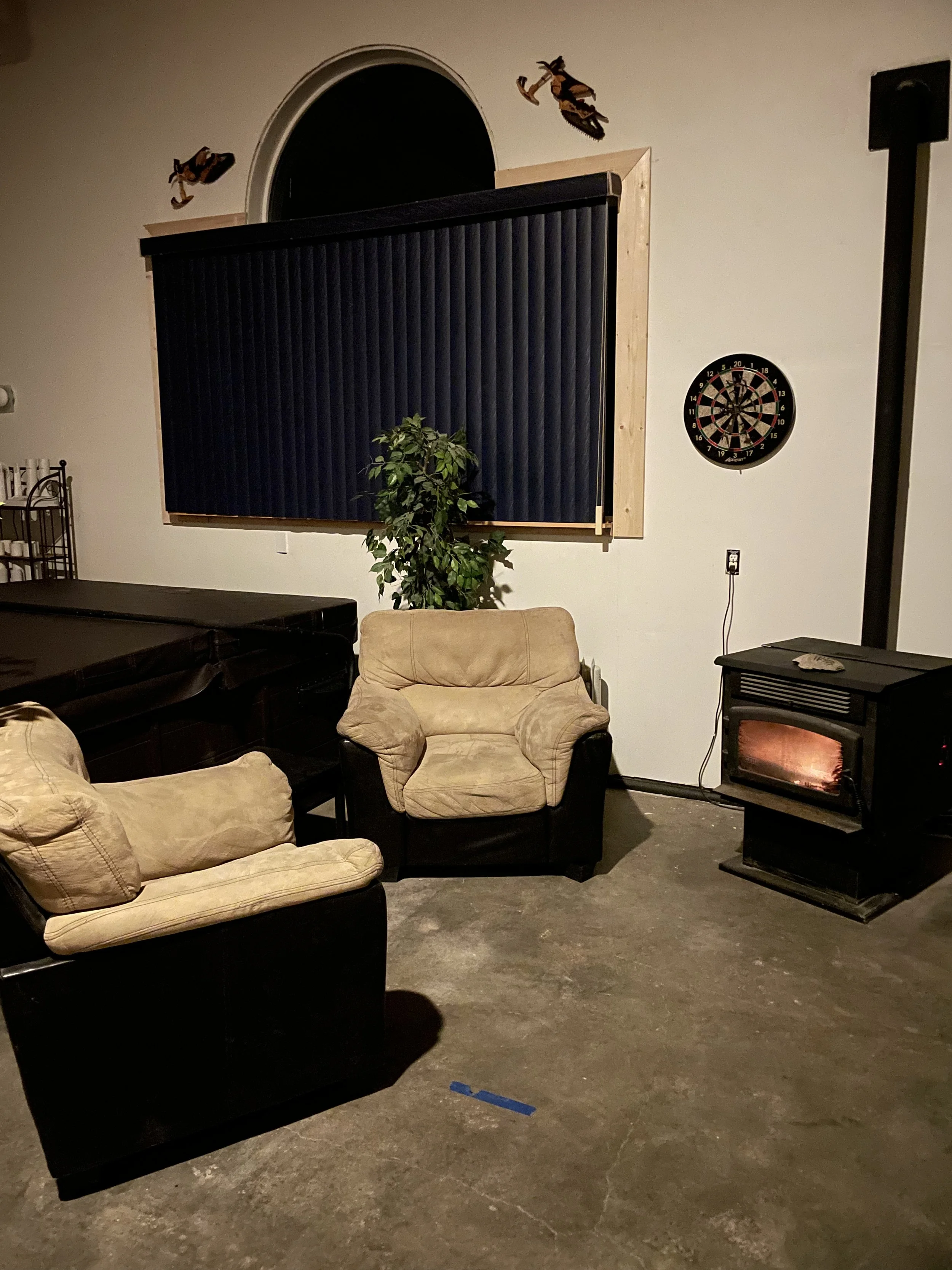 Just past the hot tub is a cozy sitting area where you can relax and watch the gentle flicker of the pellet‑stove flames — the perfect place to unwind after a long day. A darts game nearby adds a fun touch if you’re in the mood for a little friendly 