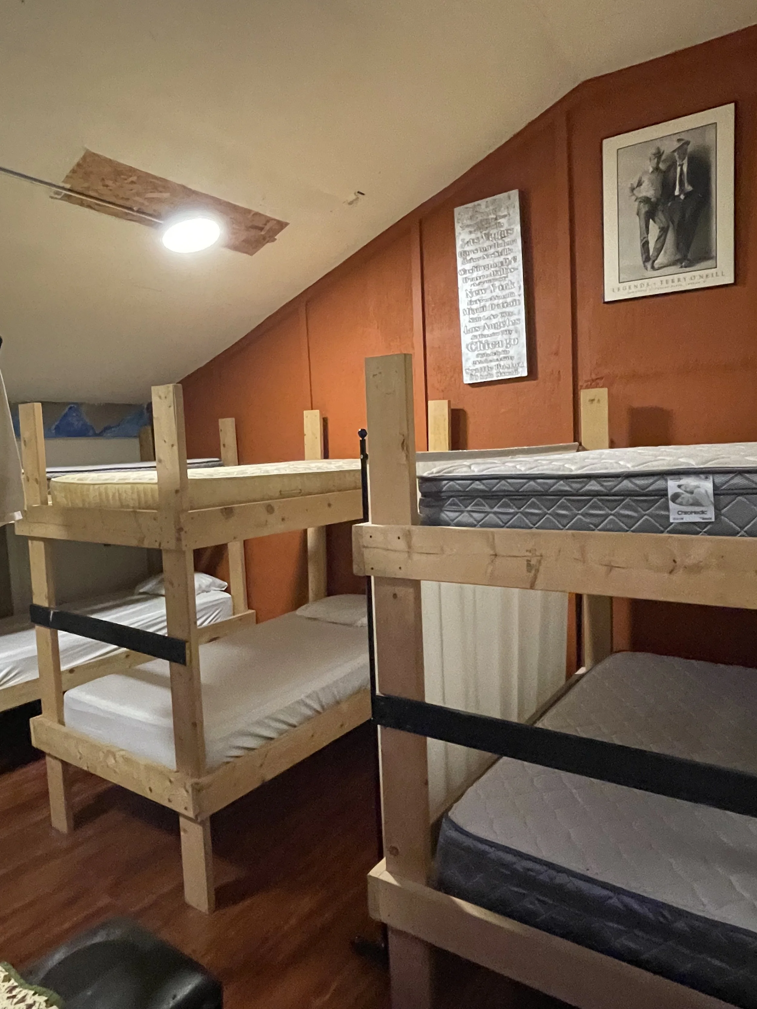 The room features three cabin‑style bunk beds, each made up with fresh sheets, clean bedding, and pillows, providing cozy and comfortable sleeping spaces for guests.”