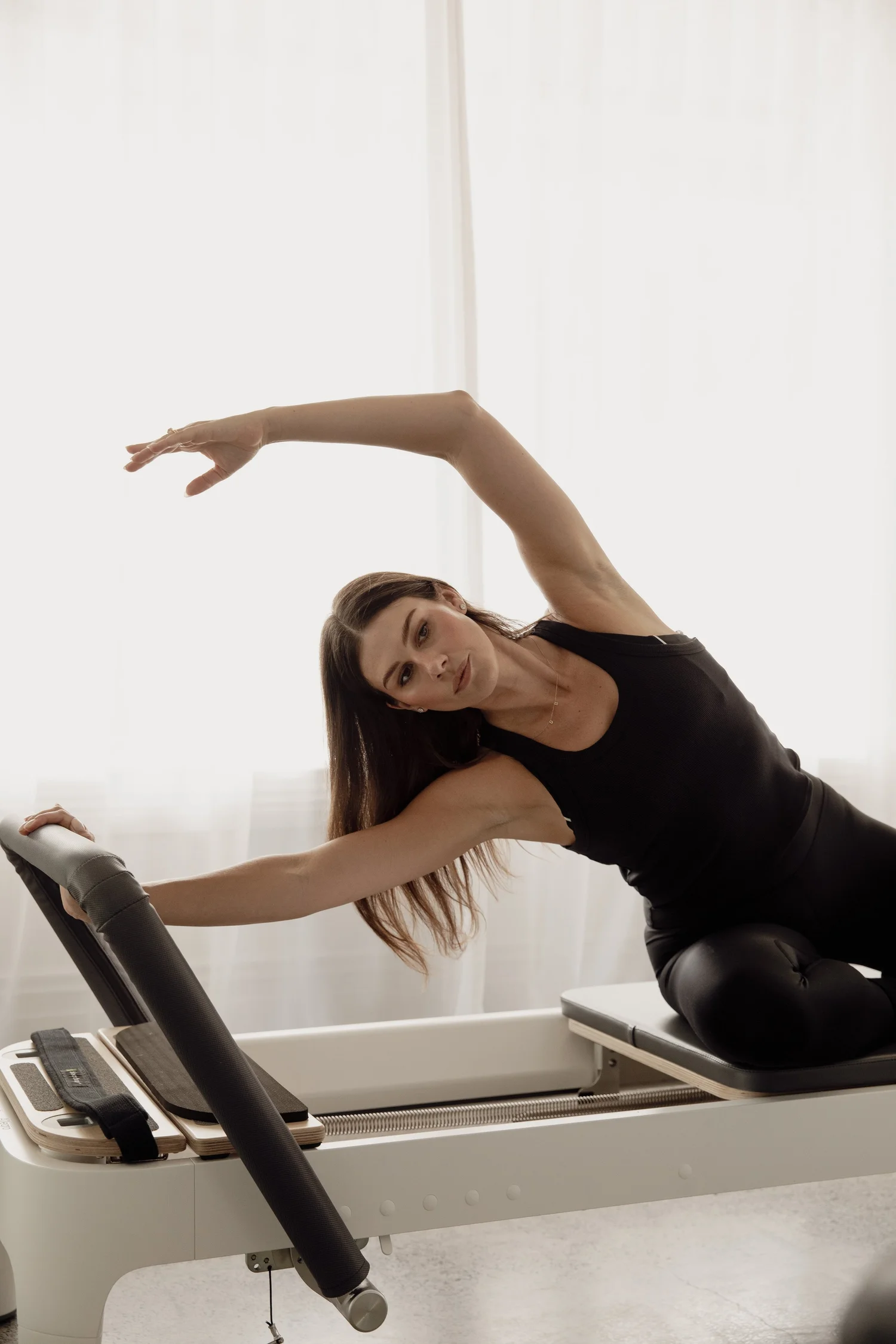 Side stretch on the reformer at Anna Jane Pilates, Herne Bay