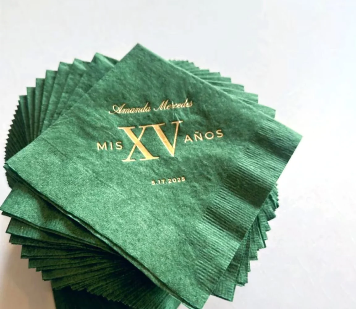 Green napkins with gold lettering celebrating Amanda Mercedes' 15th birthday on May 17, 2025.