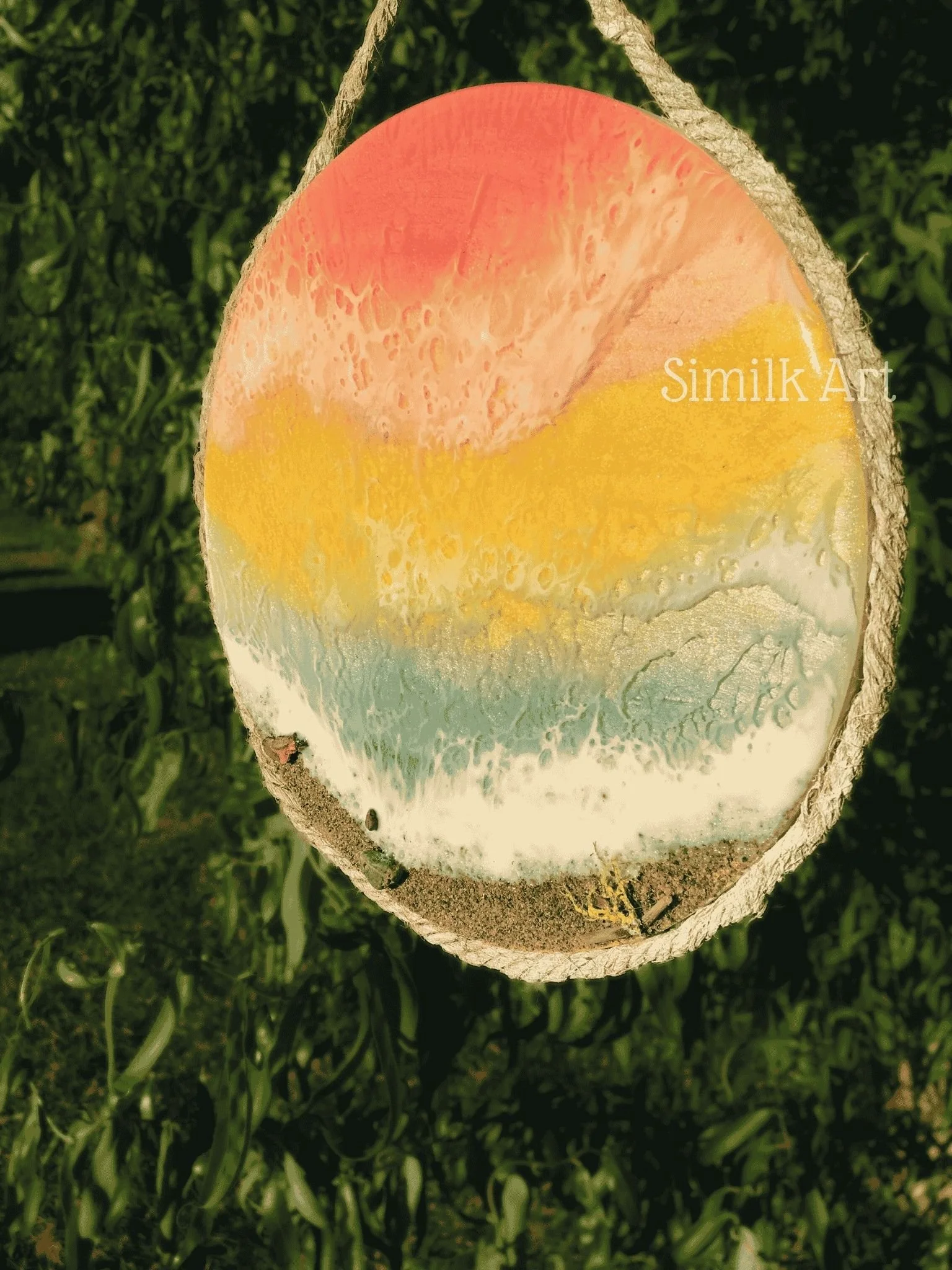 Round Mixed media wall art made of resin depicting a Rainbow ocean with waves blending with each other