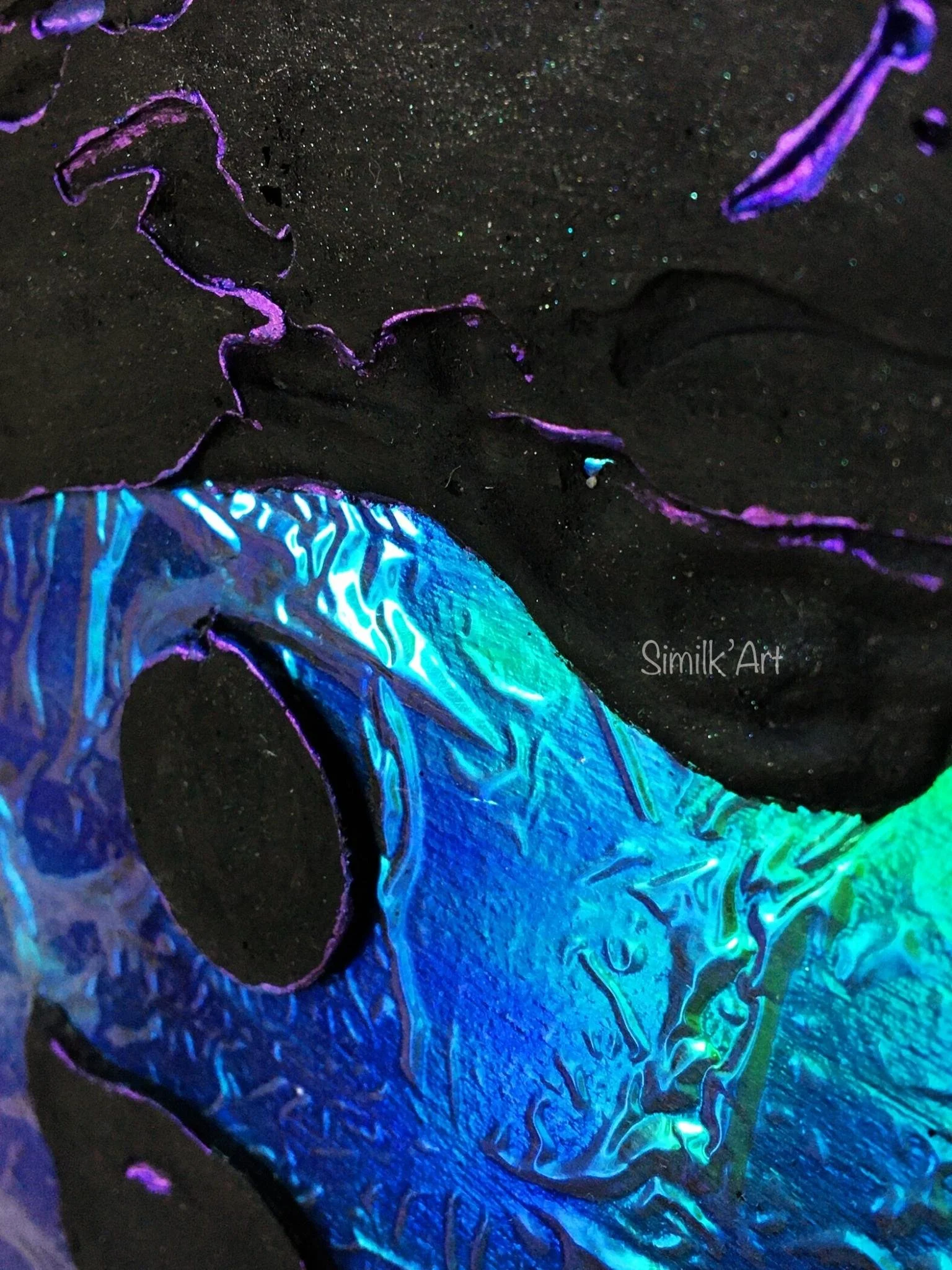 Mixed media Wall Art combining black plaster and dichroic film, which together transport you to an inert place