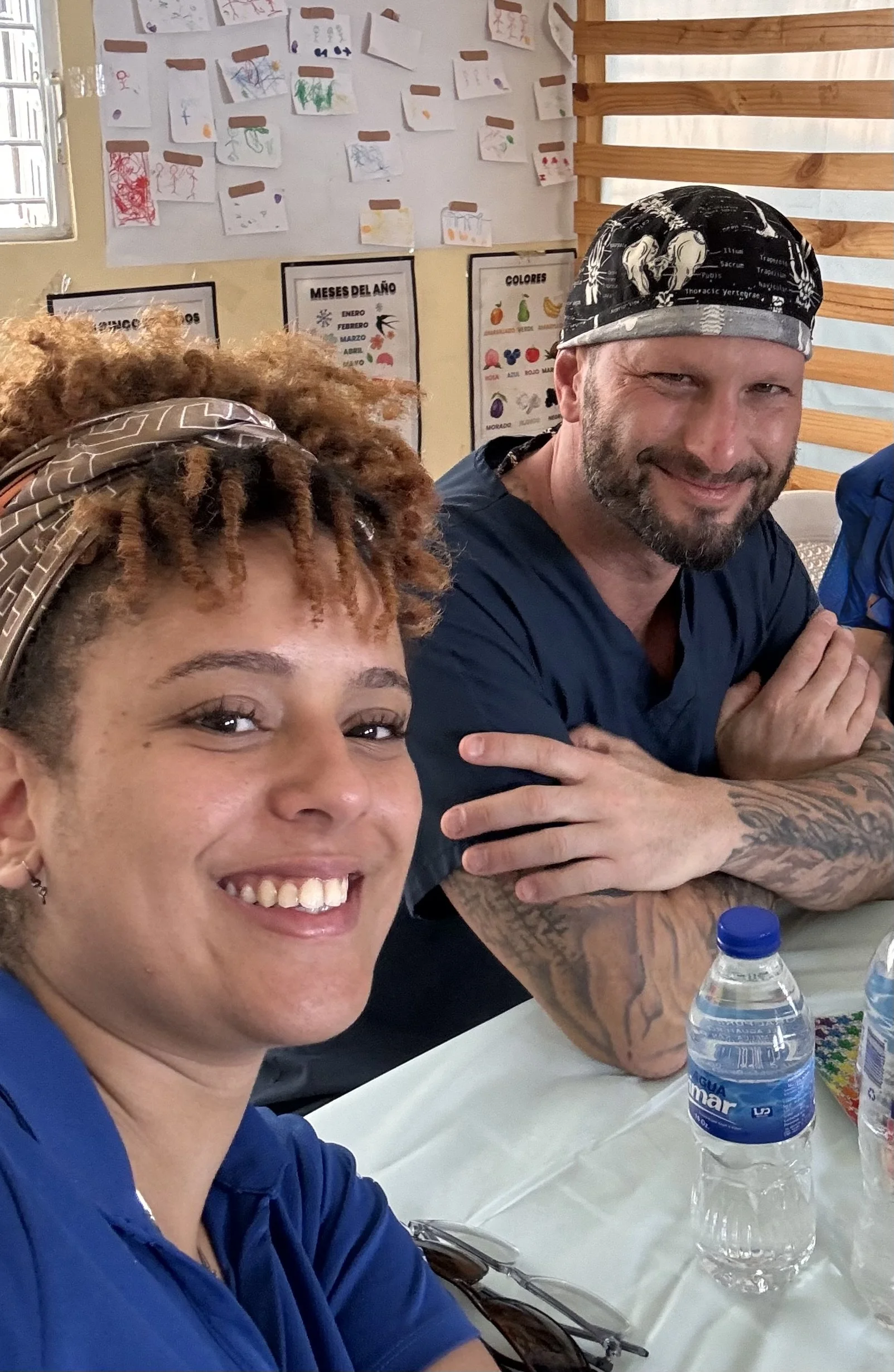 Healthier Futures International volunteers in scrubs take a selfie at a clinic during 2024 medical mission