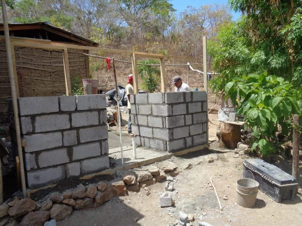 Cinder block construction in progress during Healthier Futures International's 2015 community building project