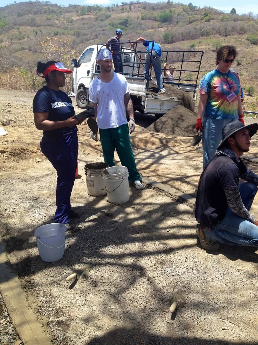 Healthier Futures International volunteers unload construction materials from a truck during 2015 mission