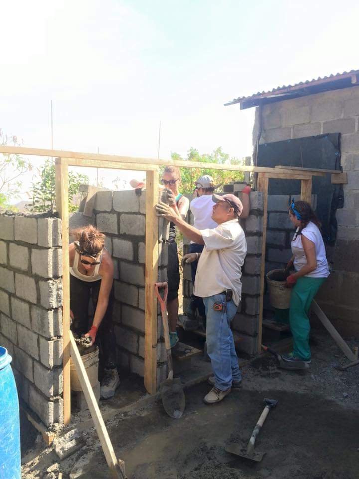 Healthier Futures International volunteers build cinder block structures in a Dominican Republic community in 2015