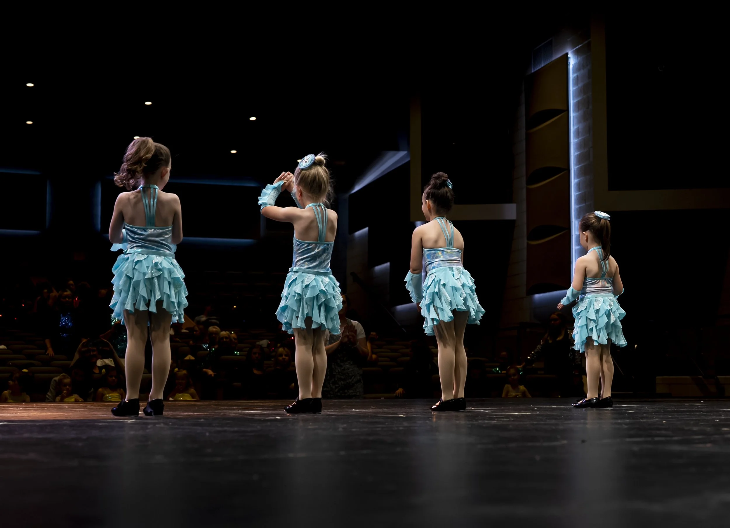 Four young girls on stage at a dance recital