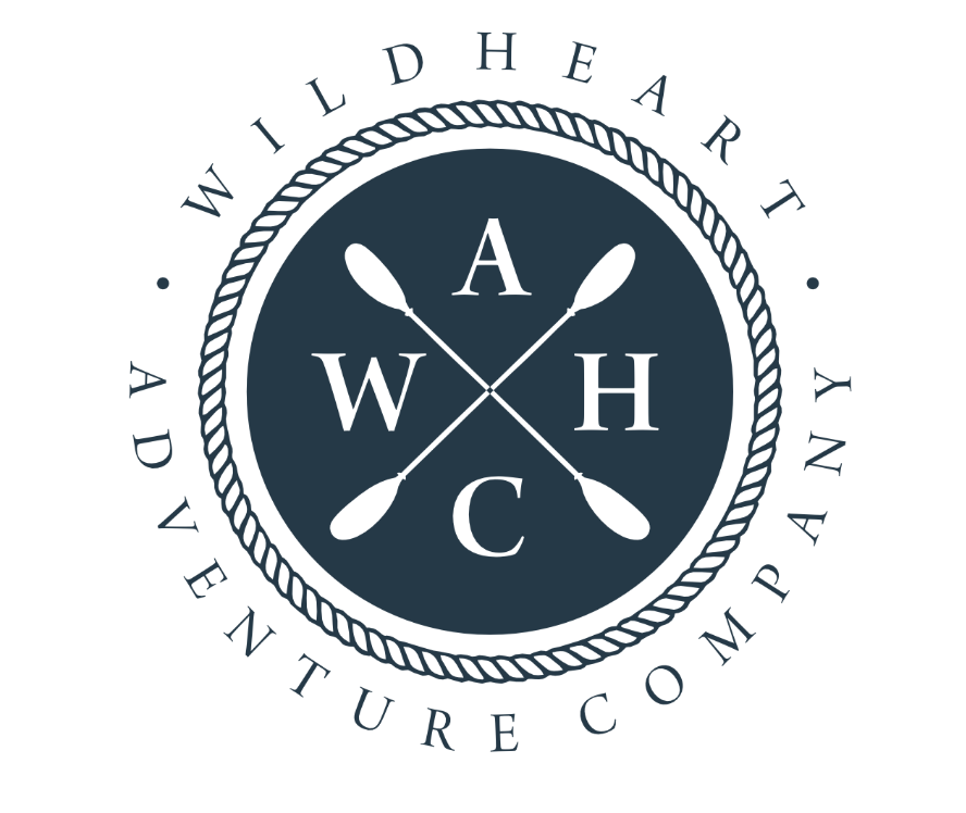 Logo for Wild Heart Adventure Company featuring crossed oars and the initials A, W, H, C inside a dark circle, surrounded by a rope border, with the company name encircling the logo.