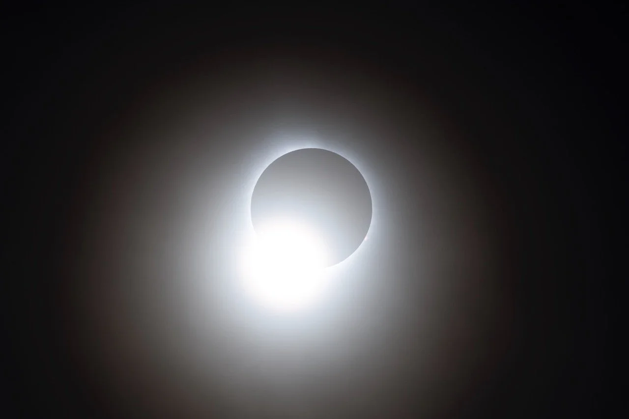 A solar eclipse where the moon partially covers the sun, creating a glowing ring of light.