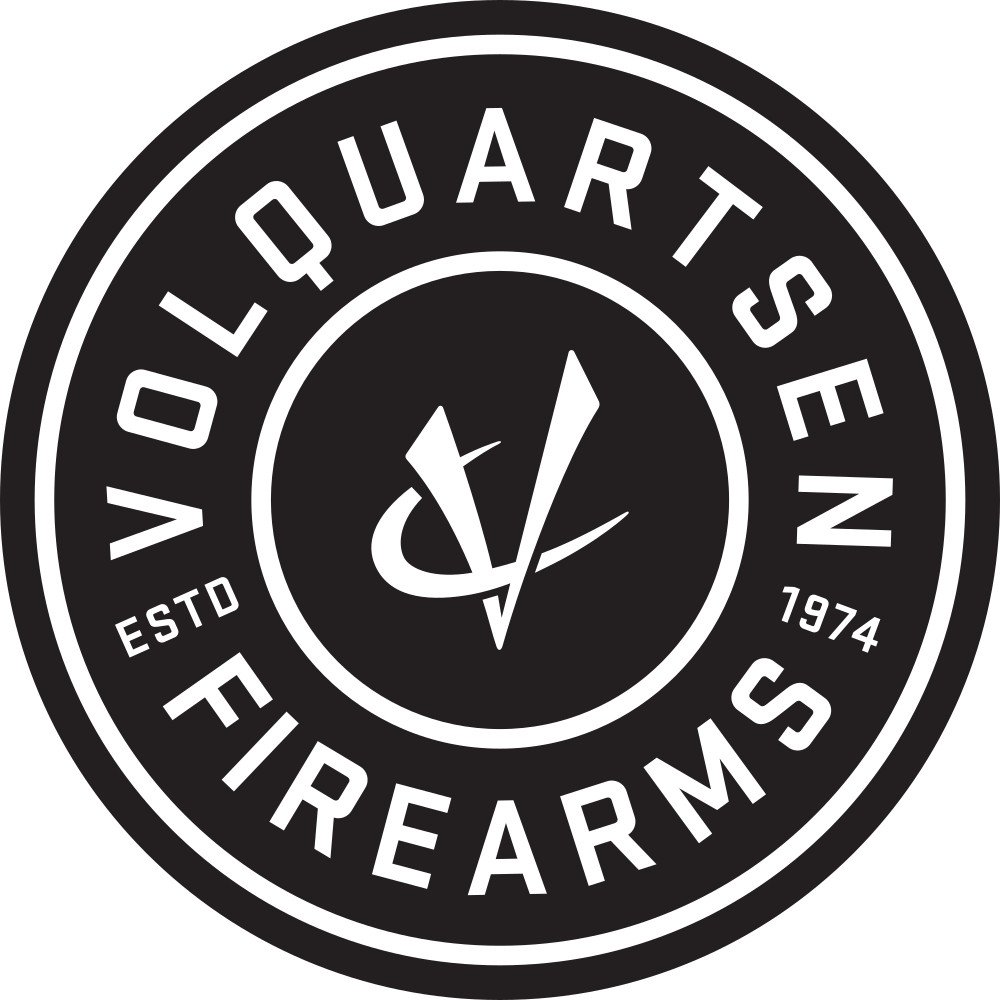 A circular black and white logo that reads 'Veterlquarters Firearms', with 'ESTD 1974' and a stylized clock in the center.