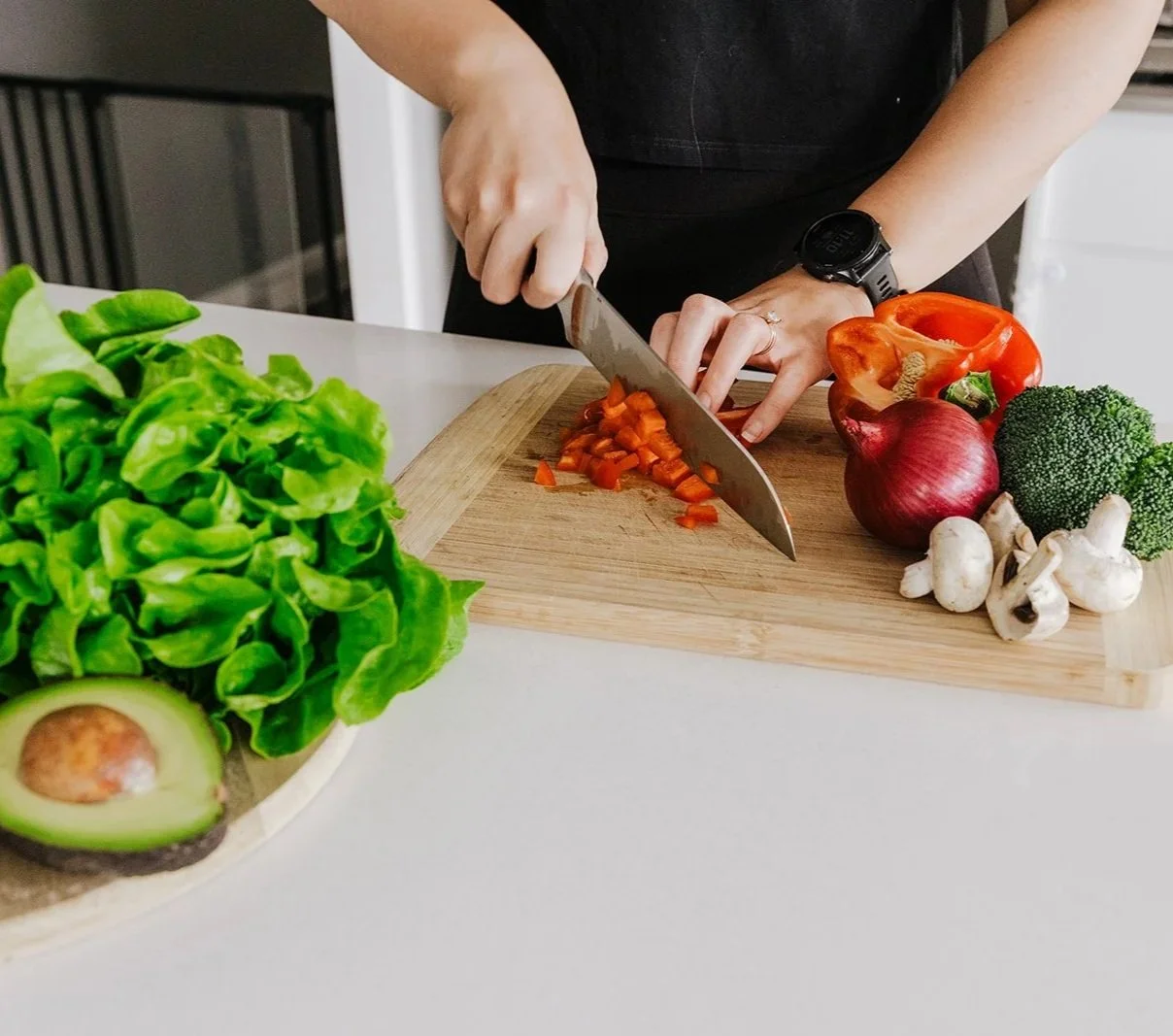 Hands chopping vegetables in a kitchen during meal preparation