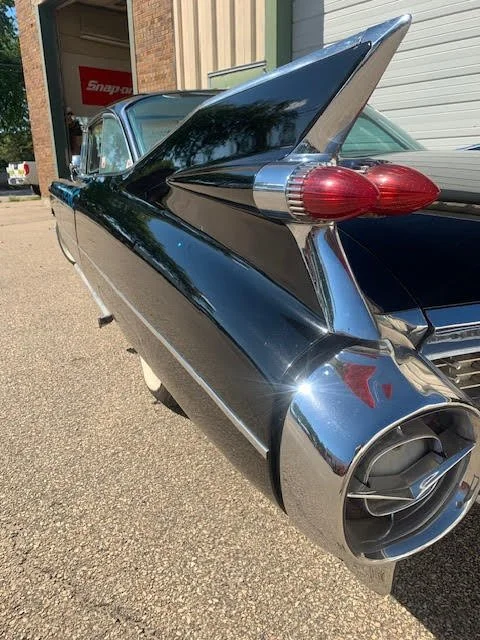 Rear view of a vintage 1959 Cadillac with tail fins and distinctive tail light design