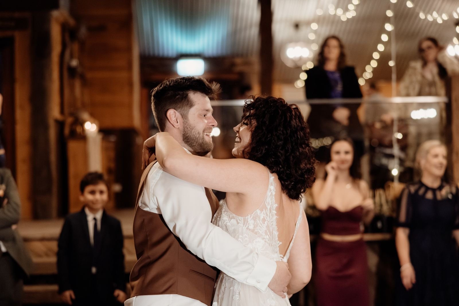 first dance as husband and wife surrounded by family and friends