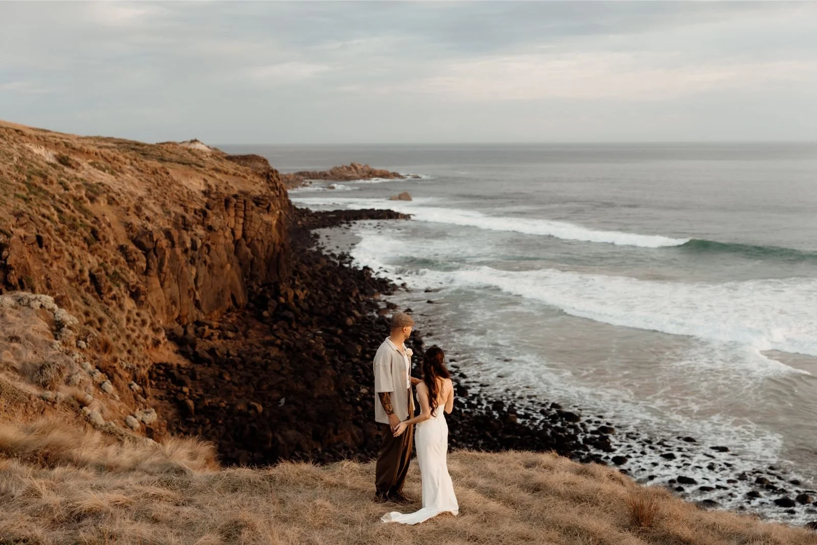bride and groom on clifftop at sunset near The Shearing Shed Phillip Island