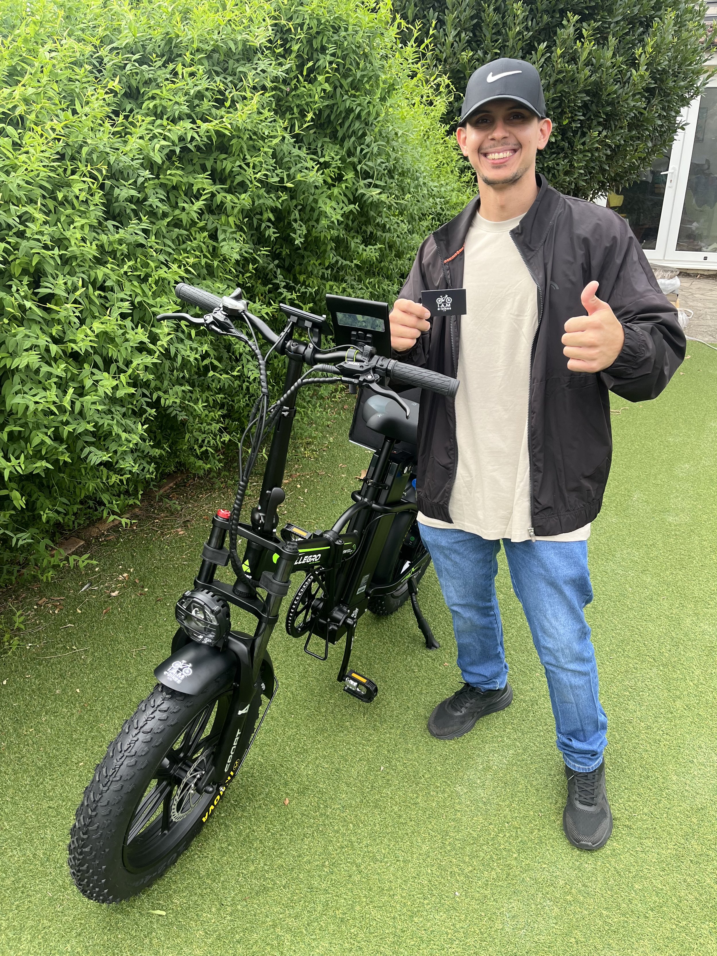 A happy customer standing next to his newly purchased Allegro electric bike that he needed for working Deliveroo and Uber Eats. He was happy with his experience hence the big smile and thumbs up. Photo taken when eRYD was Formerly I.A.M e-bikes