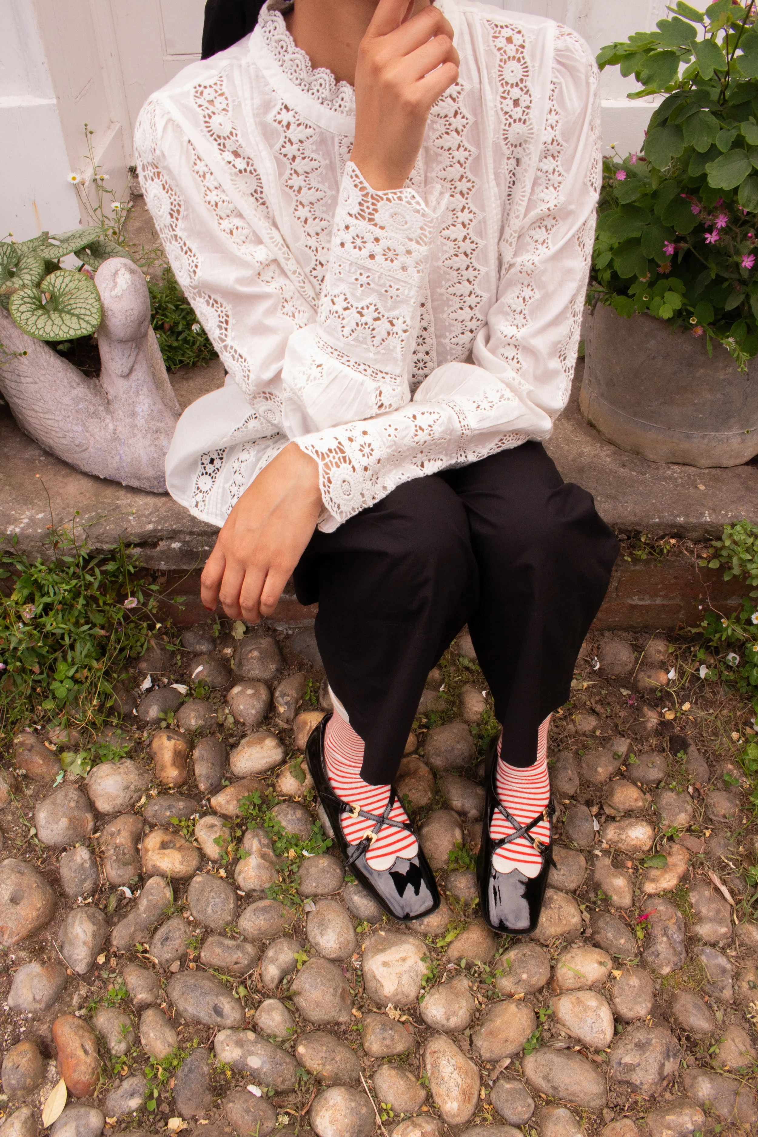 Model sitting on the doorstep at Dot Cottage during an editorial photoshoot.