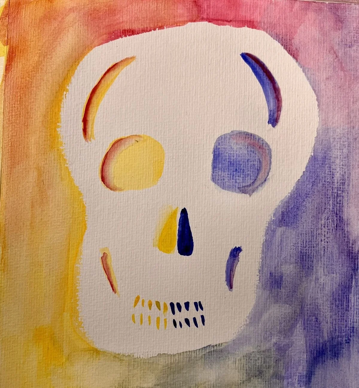 Watercolor painting of a human skull with yellow, purple, and red highlights against a colorful background.