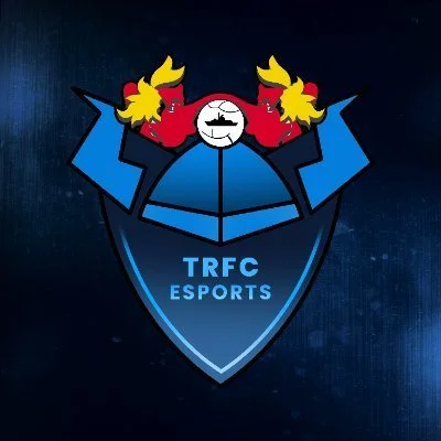 A logo of a shield with the text 'TRFC ESPORTS' and cartoon-like red faces with yellow hair in the background.